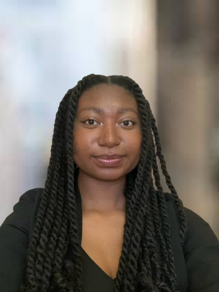 Myeisa Barnhill Young woman with braids. Wearing a black shirt.